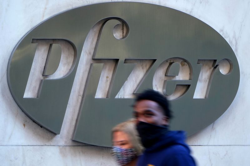 FILE PHOTO: People walk past the Pfizer headquarters building