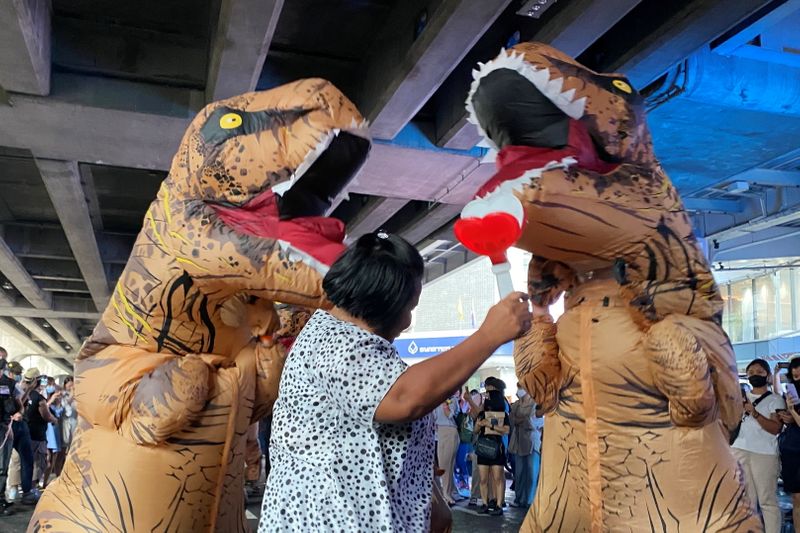 Dinosaur costumed actors representing Thailand’s establishment at a high school