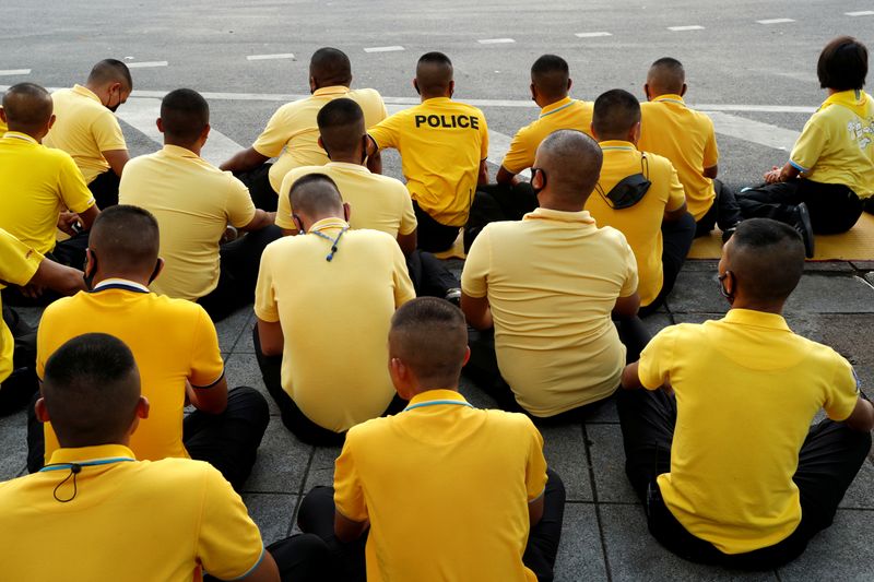 FILE PHOTO: Police officers sit on the ground after the