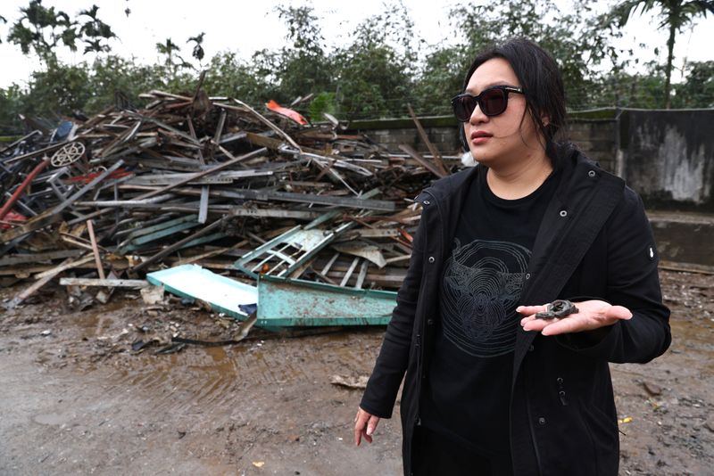 Wang looks for materials to collect at the waste storage