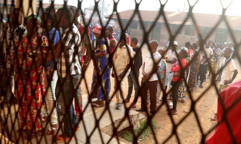 Voters queue to cast their ballots during the Presidential and