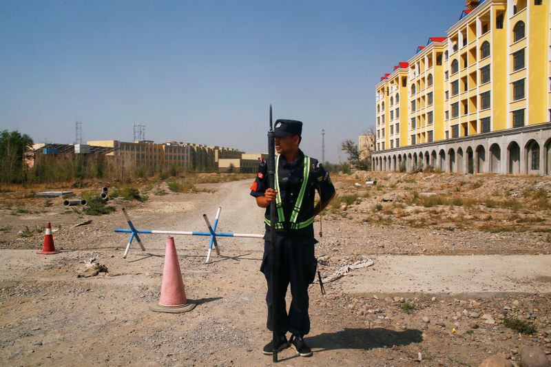 FILE PHOTO: FILE PHOTO: A Chinese police officer takes his