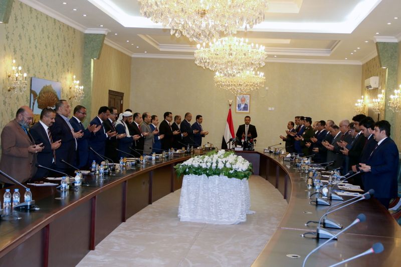 Yemeni ministers pray as they attend the first meeting of
