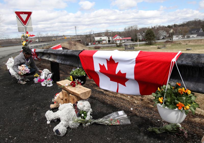 Mourners react at a memorial for RCMP Constable Heidi Stevenson,