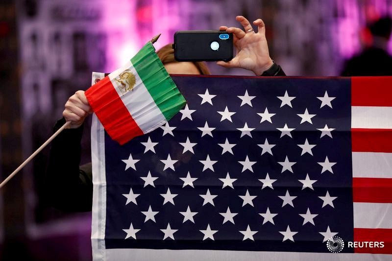 FILE PHOTO: Attendees hold flags from Iran and the United