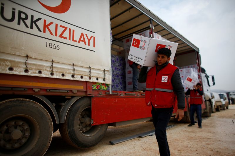 FILE PHOTO: Turkish Red Crescent workers carry humanitarian aid at