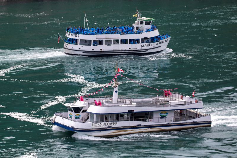 American tourist boat glides past a Canadian vessel limited to