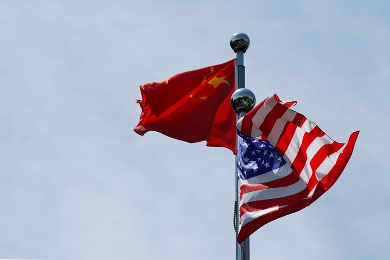 FILE PHOTO: Chinese and U.S. flags flutter near The Bund