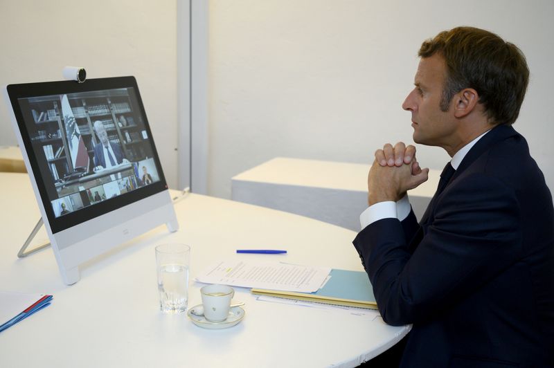 French President Emmanuel Macron attends a donor teleconference with other