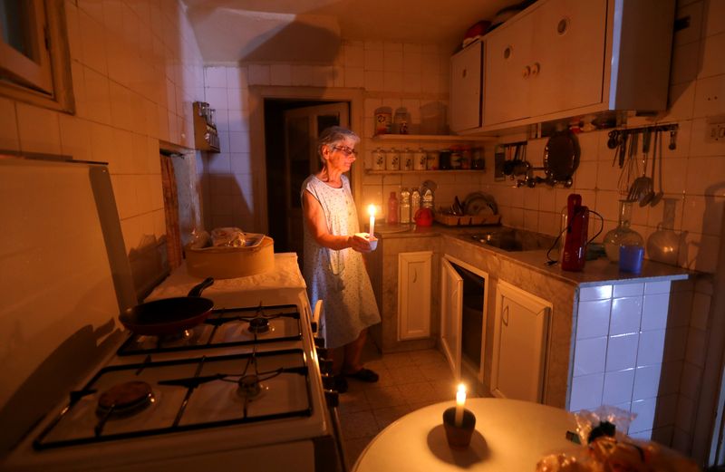 FILE PHOTO: Samira Hanna,70, walks in her kitchen as she