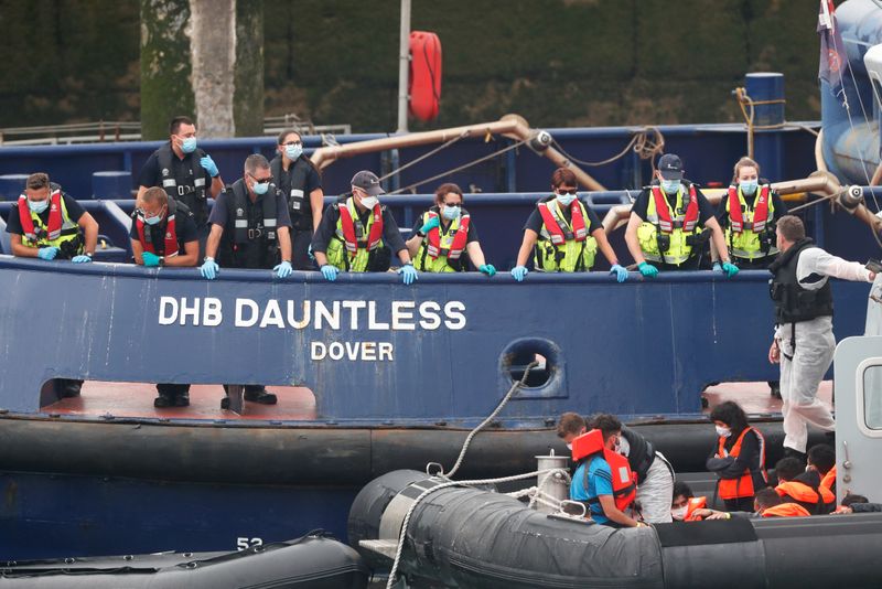 Migrants prepare to disembark at Dover harbour, in Dover