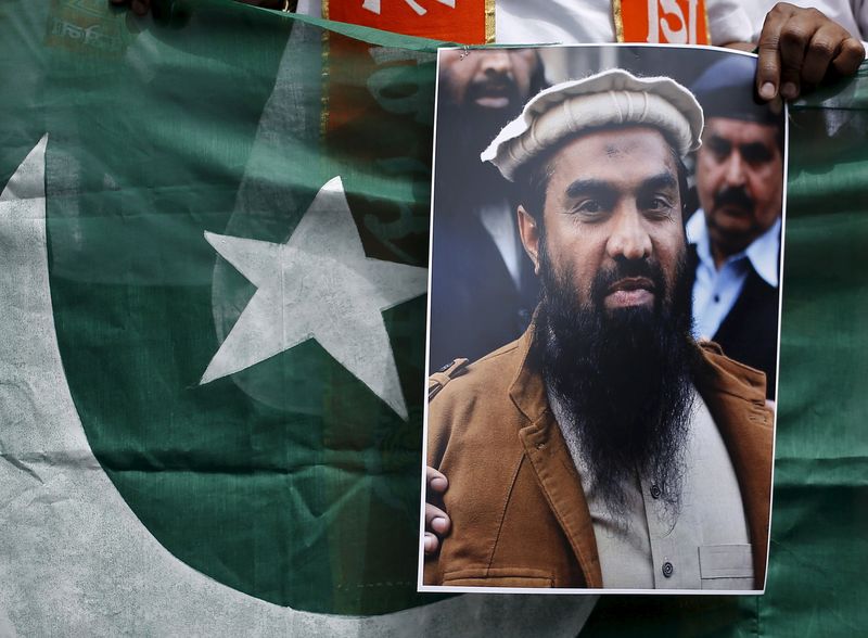 A supporter of Shiv Sena holds Pakistan’s national flag and