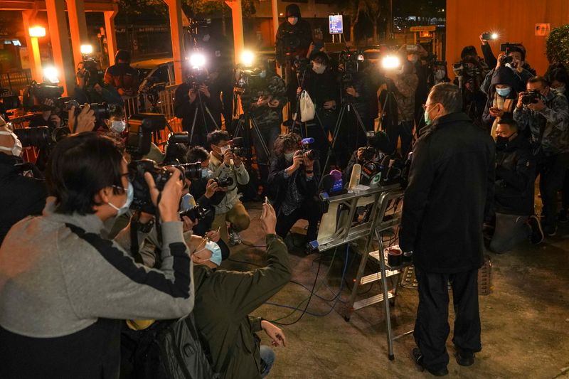 Pro-democracy activist Benny Tai talks to media as he leaves