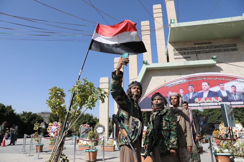 Members of the Houthi movement take a selfie near the