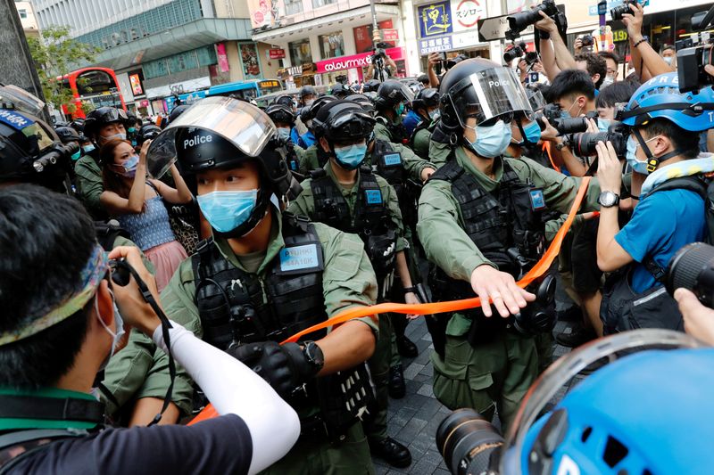FILE PHOTO: Riot police disperse pro-democracy protesters during a demonstration