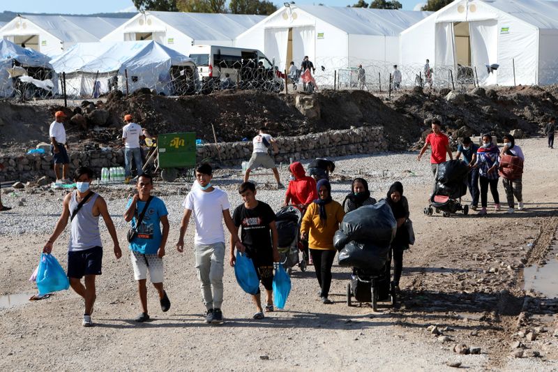 FILE PHOTO: Refugees and migrants make their way in the