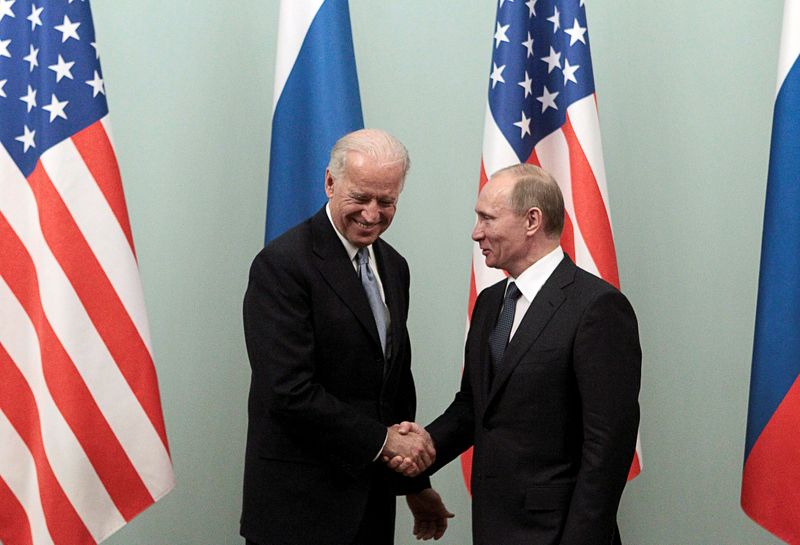 FILE PHOTO: Russian Prime Minister Putin shakes hands with U.S.