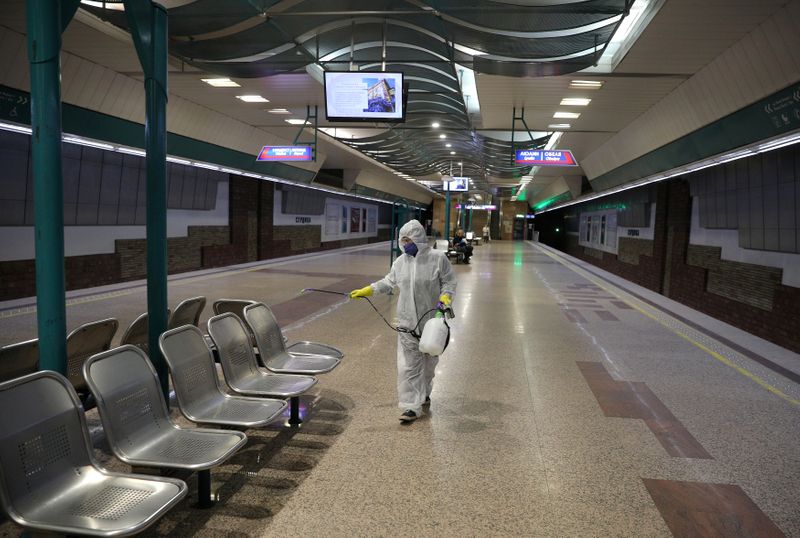Worker sprays disinfectant in Serdika metro station in Sofia