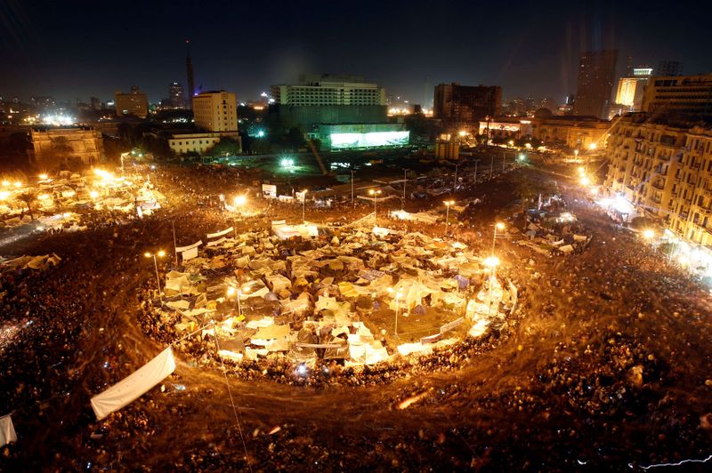 FILE PHOTO: Anti-government protesters in Cairo’s Tahrir Square listen as