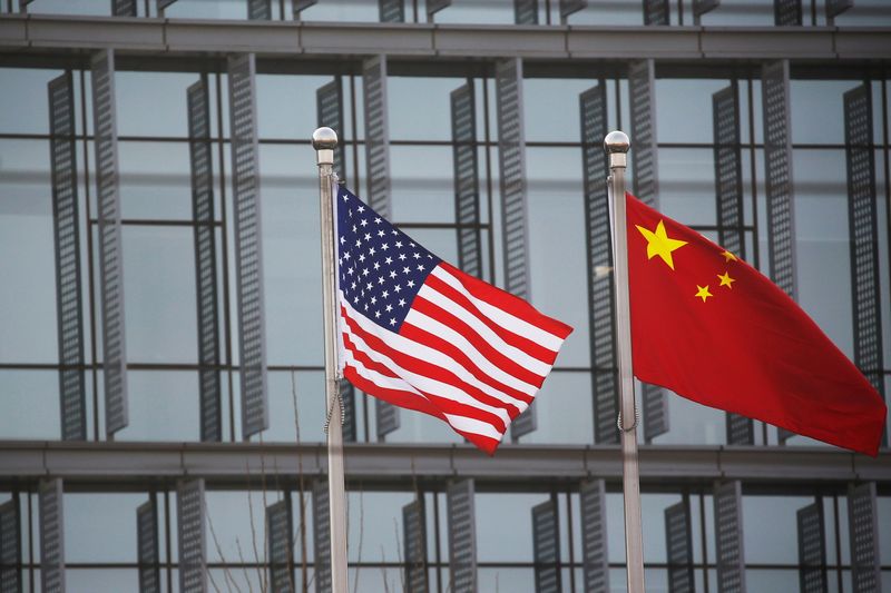 Chinese and U.S. flags flutter outside the building of an