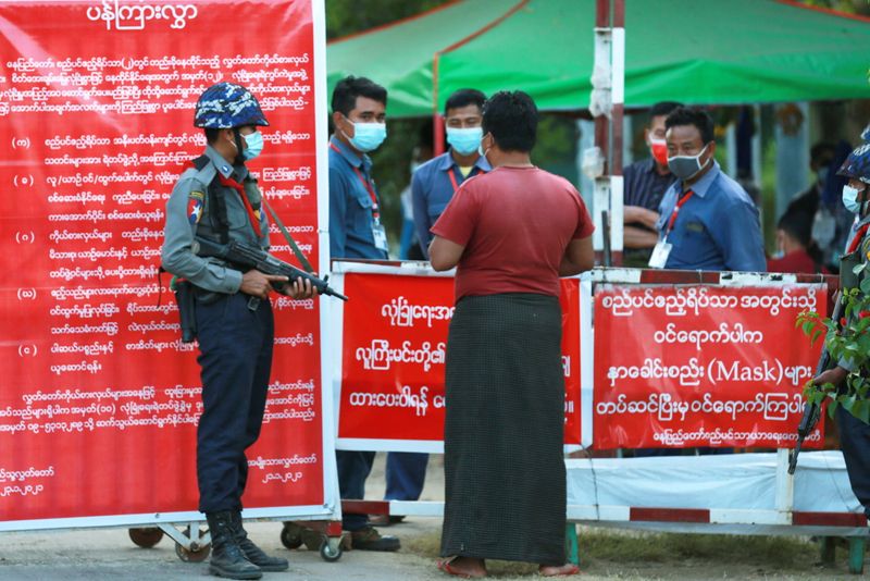 Myanmar’s police officers stand guard at the entrance of parliament