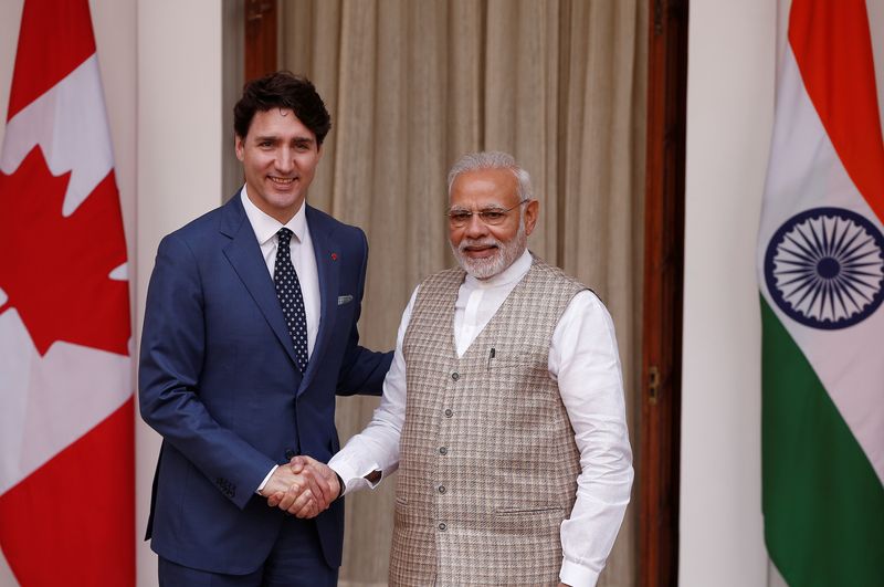 FILE PHOTO: Canadian Prime Minister Justin Trudeau (L) shakes hands