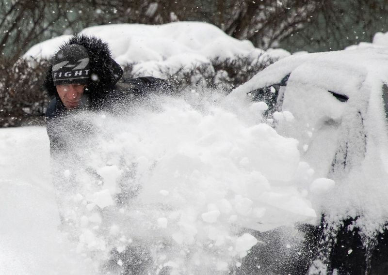 A worker removes snow in a street in Moscow