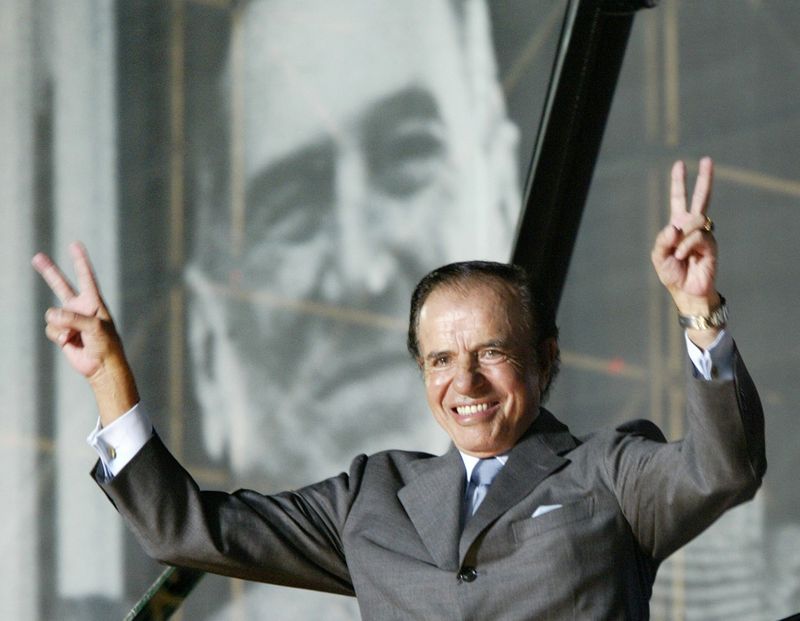 FILE PHOTO: Argentine presidential candidate Carlos Menem waves to thousands