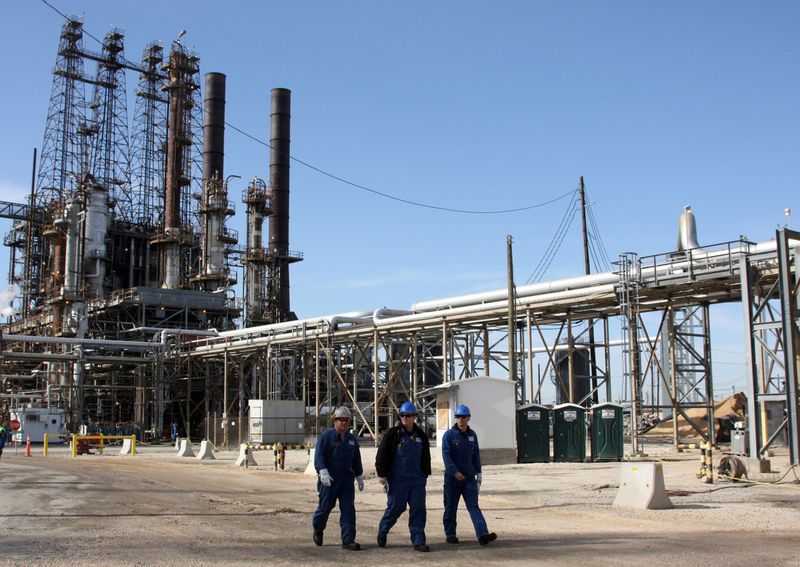 FILE PHOTO: Refinery workers walk inside the LyondellBasell oil refinery