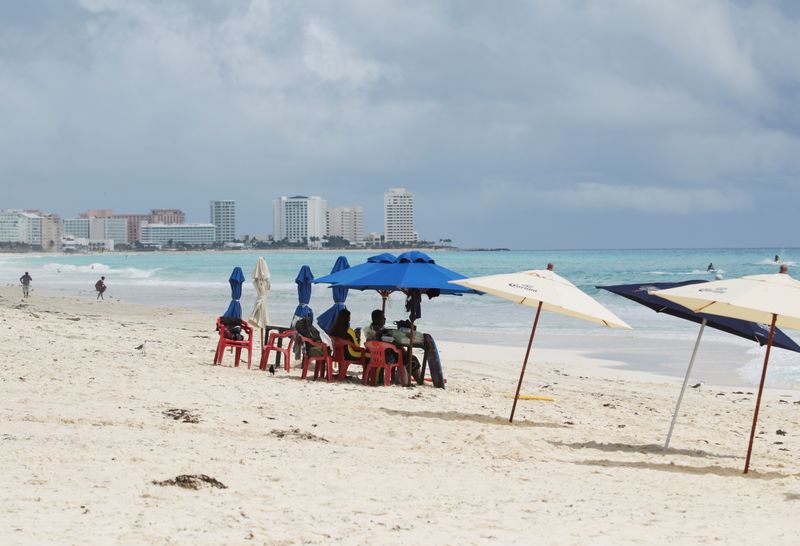 FILE PHOTO: Tourists are seen at a beach in Cancun