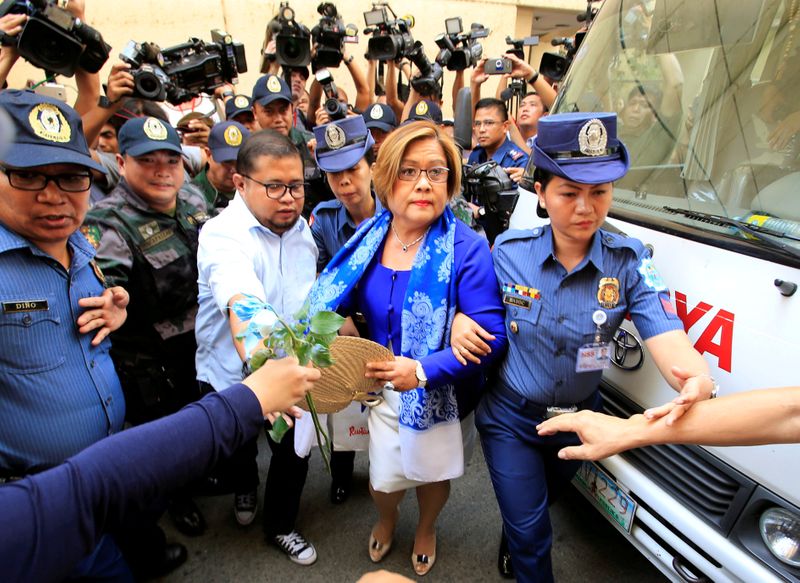 FILE PHOTO: Philippine police escort Leila de Lima, a senator