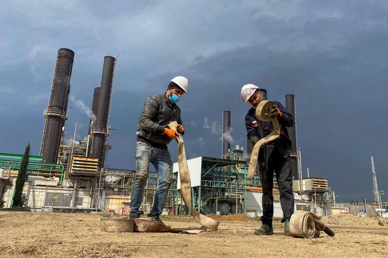 Workers are seen at Gaza’s lone power plant, in the