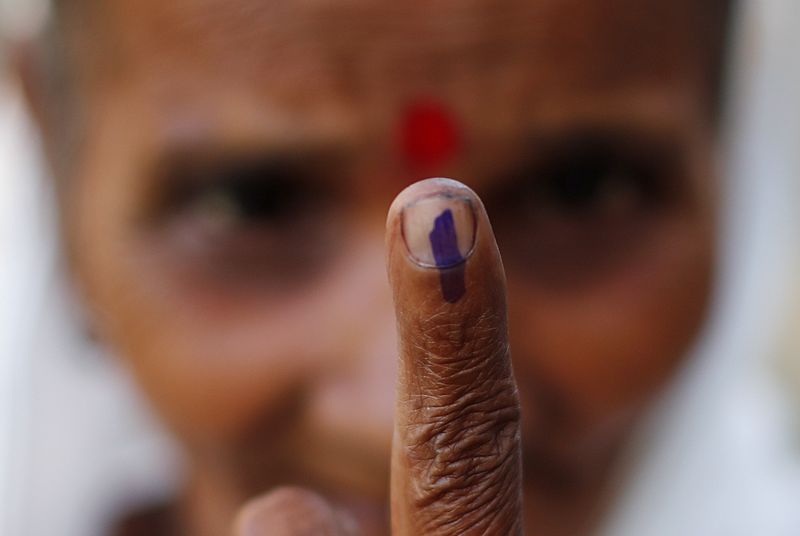 FILE PHOTO: A woman shows her ink-marked finger after casting
