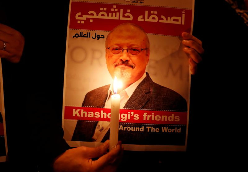FILE PHOTO: A demonstrator holds a poster with a picture