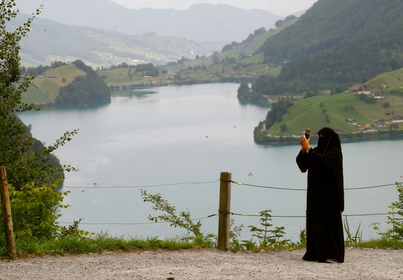 FILE PHOTO: A woman takes a picture from a lookout