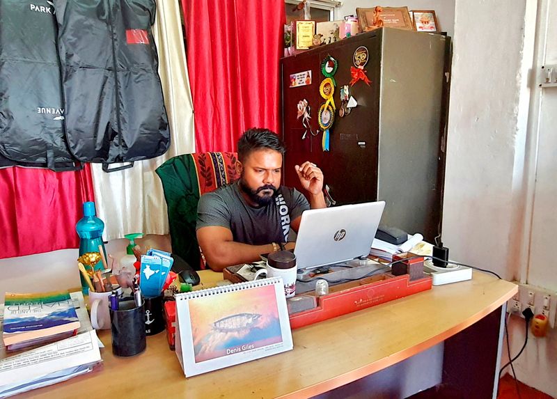 Denis Giles works inside his office in Port Blair