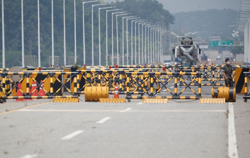 FILE PHOTO: A soldier stands guard at a checkpoint on