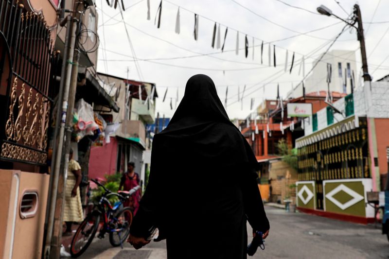 FILE PHOTO: A Muslim woman wearing a hijab walks through