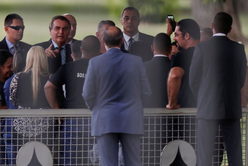 Brazil’s President Bolsonaro talks with supporters upon arrival at Alvorada