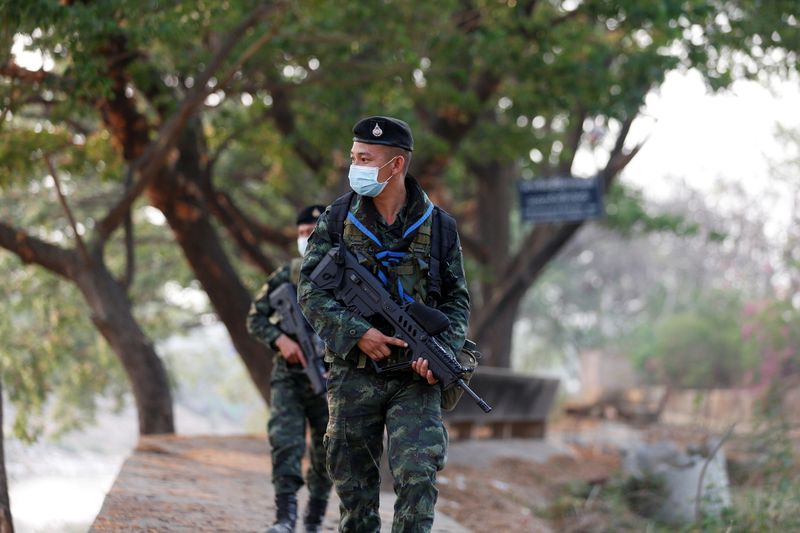 Thai border guards walk a they patrol at Myanmar border