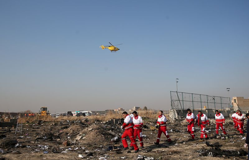 FILE PHOTO: Rescue team works among debris of a plane