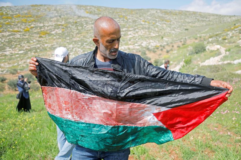Palestinians protest against Israeli settlements in the occupied West Bank