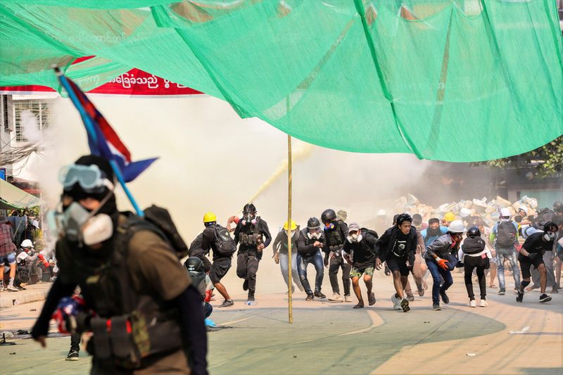 FILE PHOTO: Protesters run during a crackdown of an anti-coup