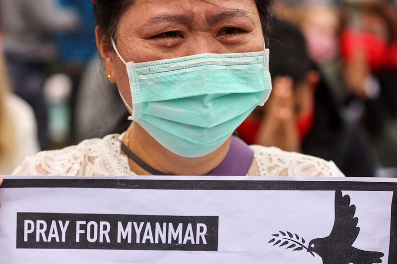 A woman cries during a gathering to denounce the Myanmar