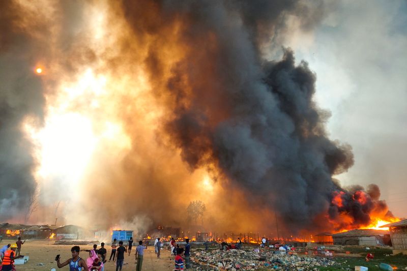 Smoke billows at the site of the Rohingya refugee camp