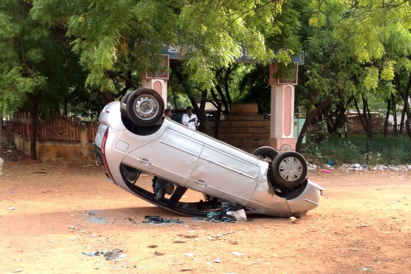 A toppled vehicle is pictured near a government office, after