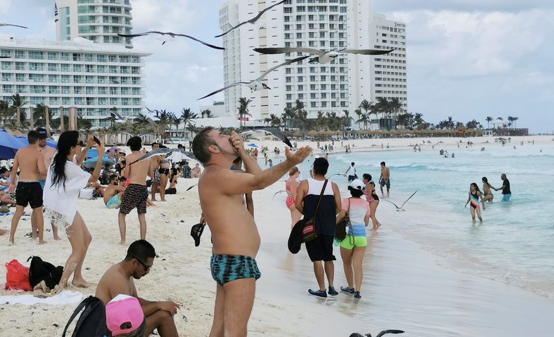 FILE PHOTO: Tourists enjoy a public beach in Cancun