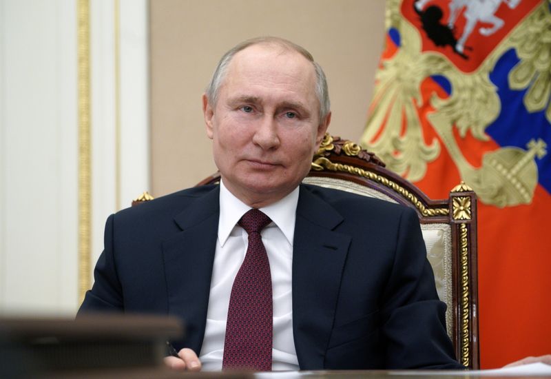Russian President Vladimir Putin takes part in a video conference