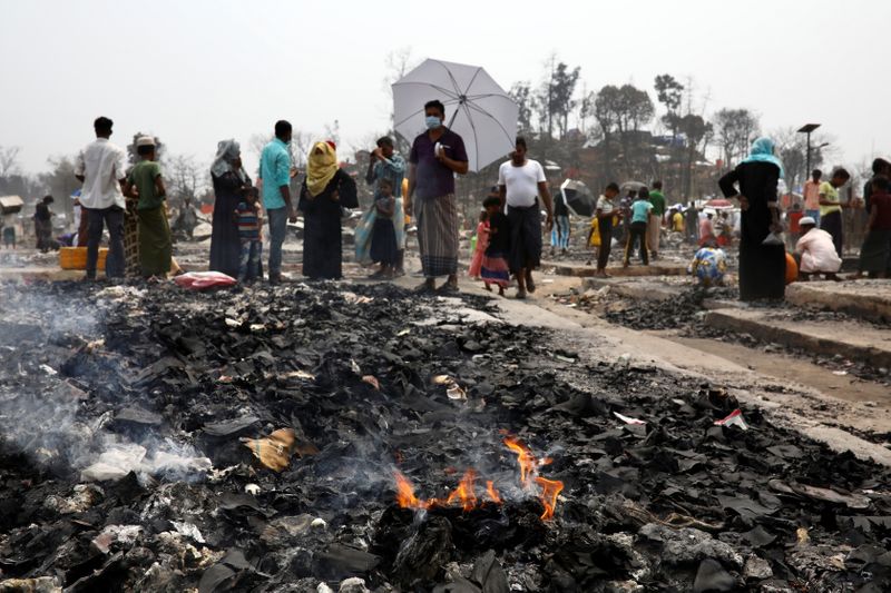 Fire is seen at the Rohingya refugee camp where a