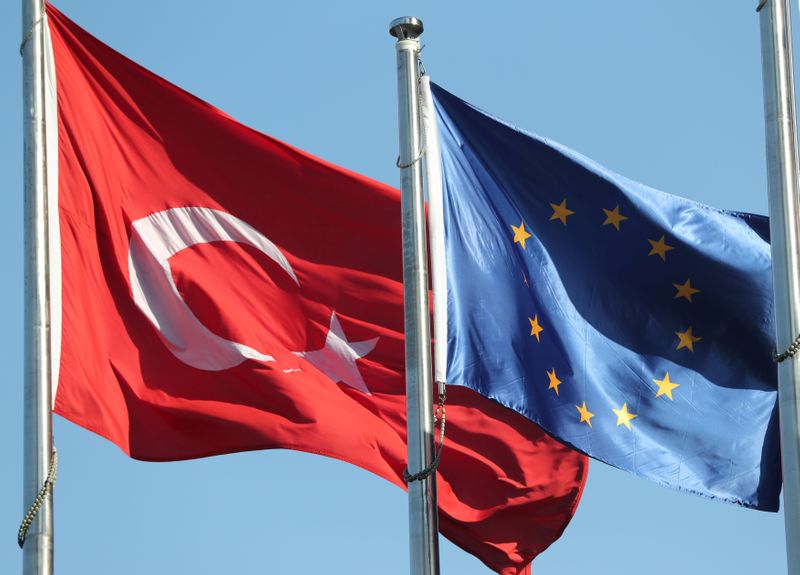 European Union and Turkish flags fly at the business and